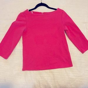 Bright pink three quarter length sleeve shirt.